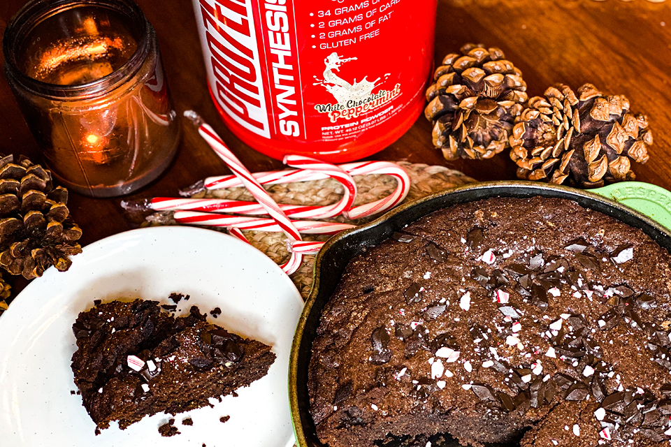 brownies sitting on a plate with a Nutrishop protein powder in the background